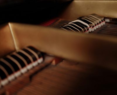 Detailed view of piano strings and hammers, showcasing intricate mechanics.